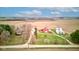 An aerial perspective captures a vintage farm with its bright red barn, farmhouse, multiple silos, and surrounding foliage at 10573 W 550 N, Thorntown, IN 46071
