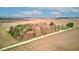 Wide aerial shot of the landscape with a road winding through farmlands and dense forest, and several structures at 10573 W 550 N, Thorntown, IN 46071