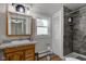 This bathroom has a wood grain vanity, a window, and a tiled shower at 10573 W 550 N, Thorntown, IN 46071