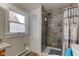 This bathroom has a tiled shower, a window, and a clean toilet area at 10573 W 550 N, Thorntown, IN 46071