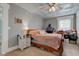 This bedroom features a ceiling fan, charming decor, and natural light from a window at 10573 W 550 N, Thorntown, IN 46071