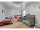 This bedroom features two beds, a shelf of toys, and charming decor at 10573 W 550 N, Thorntown, IN 46071