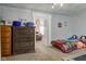View of a bedroom with playful decorations, bed, dresser, and unique decorative ceiling tiles at 10573 W 550 N, Thorntown, IN 46071