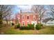 Charming two-story red brick home with white trim and manicured landscaping adding to its curb appeal at 10573 W 550 N, Thorntown, IN 46071