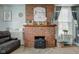 Close-up of a brick fireplace with decorative accents in a cozy living room setting at 10573 W 550 N, Thorntown, IN 46071