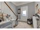 Charming hallway with carpeted floors, white trim, staircase, and decorative elements at 10573 W 550 N, Thorntown, IN 46071