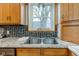 Close up of a kitchen sink with stainless steel fixtures, granite countertops and wood cabinets at 10573 W 550 N, Thorntown, IN 46071