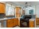 Kitchen featuring wood cabinets, granite counters and backsplash at 10573 W 550 N, Thorntown, IN 46071