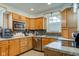 Traditional kitchen with wooden cabinets, stainless appliances, and cozy breakfast bar at 10573 W 550 N, Thorntown, IN 46071