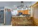 Open kitchen with custom wood breakfast bar, stainless appliances, and stylish lighting at 10573 W 550 N, Thorntown, IN 46071