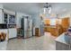 Open floor plan kitchen with two stainless steel refrigerators, wooden cabinets, and unique tin style ceiling at 10573 W 550 N, Thorntown, IN 46071