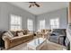 Comfortable living room with neutral walls, carpeted floors, ample seating, and natural light from windows at 10573 W 550 N, Thorntown, IN 46071