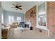 Comfortable living room with brick accent wall, fireplace, and cozy seating arrangement at 10573 W 550 N, Thorntown, IN 46071