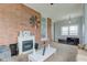 Relaxing living room boasting a brick accent wall with a fireplace and ample natural light at 10573 W 550 N, Thorntown, IN 46071