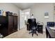 Cozy office area with dark wood furniture, neutral walls and carpet, with a view into another room at 10573 W 550 N, Thorntown, IN 46071