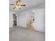 Bedroom showcasing neutral carpet and an open doorway leading to the kitchen at 13381 N White Cloud Ct, Camby, IN 46113