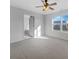 A bright bedroom that features a ceiling fan and a large window, with an ensuite bathroom at 13381 N White Cloud Ct, Camby, IN 46113