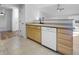 Kitchen with a dishwasher and sink with oak cabinets and a view into the living area at 13381 N White Cloud Ct, Camby, IN 46113