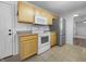 Functional kitchen featuring light wood cabinets, white appliances, and a practical layout at 13381 N White Cloud Ct, Camby, IN 46113