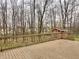 A large wooden deck overlooking a lush backyard with mature trees and a storage shed at 1426 Ripplewood Dr, Danville, IN 46122