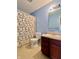 Well-lit bathroom with a vanity, toilet, and a shower featuring a decorative, patterned shower curtain at 1426 Ripplewood Dr, Danville, IN 46122