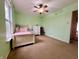 Bedroom boasting a ceiling fan, a cozy bed, and a window with a pleasant view of the outdoors at 1426 Ripplewood Dr, Danville, IN 46122