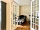 A bedroom that features glass french doors, a modern bed frame and hardwood floors at 1426 Ripplewood Dr, Danville, IN 46122