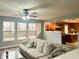 Spacious living room with hardwood floors, a large sectional sofa, and an open layout to the kitchen at 1426 Ripplewood Dr, Danville, IN 46122