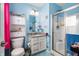 Bright blue bathroom featuring a shower with glass doors and a vanity with storage at 15046 Sullivan Ln, Westfield, IN 46074