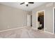 Carpeted bedroom with beige walls and a doorway to an ensuite bathroom at 15046 Sullivan Ln, Westfield, IN 46074