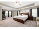 Spacious bedroom features a tray ceiling, a ceiling fan, carpet flooring, and large windows at 15046 Sullivan Ln, Westfield, IN 46074