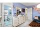 Pastel-colored bedroom featuring a large dresser, and a doorway to the ensuite bathroom at 15046 Sullivan Ln, Westfield, IN 46074