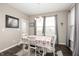 Bright dining area featuring a floral tablecloth, natural light, and a view of the backyard at 15046 Sullivan Ln, Westfield, IN 46074