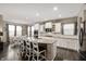 A spacious, bright kitchen with an island, bar stool seating, stainless appliances and adjacent dining area at 15046 Sullivan Ln, Westfield, IN 46074