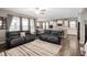 An open concept living room features hardwood floors, two sofas, a ceiling fan, and an adjacent kitchen at 15046 Sullivan Ln, Westfield, IN 46074