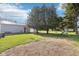 Spacious backyard, with a large barn, mature trees, and a playset at 1617 S N St, Elwood, IN 46036