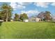 Wide shot of backyard featuring manicured lawn and detached garage at 1617 S N St, Elwood, IN 46036