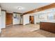 Open basement layout with wood accents, a kitchen area, and direct access to a bathroom at 1617 S N St, Elwood, IN 46036