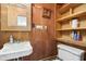 Cozy bathroom featuring wood paneled walls, a sink, and shelves at 1617 S N St, Elwood, IN 46036