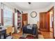 Dining room with hardwood floors, a large clock, and a window at 1617 S N St, Elwood, IN 46036