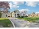 Traditional home with a spacious front yard, mature trees, and a detached garage at 1617 S N St, Elwood, IN 46036
