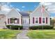 Quaint home featuring red shutters, neat landscaping, and an inviting walkway to the front door at 1617 S N St, Elwood, IN 46036
