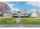 Charming single-Gathering home with a well-manicured lawn and patriotic American flag at 1617 S N St, Elwood, IN 46036