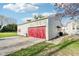 Detached garage features red garage door and siding, plus a concrete driveway at 1617 S N St, Elwood, IN 46036