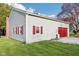 Detached garage features red shutters and garage door complemented by light gray siding at 1617 S N St, Elwood, IN 46036