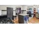 Spacious kitchen with island, dark wood cabinets, and view into the living room at 1617 S N St, Elwood, IN 46036