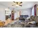 Inviting living room with gray sofa, ceiling fan, and doorway to kitchen at 1617 S N St, Elwood, IN 46036