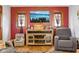 Close up of the large screen television and reclining furniture in the living room at 1617 S N St, Elwood, IN 46036