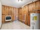 Utility room featuring a water heater, a gas heater and tile floors at 1617 S N St, Elwood, IN 46036