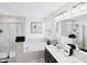Well-lit bathroom with shower, soaking tub, double vanity, and elegant gray tile at 18203 Sunbrook Way, Westfield, IN 46074